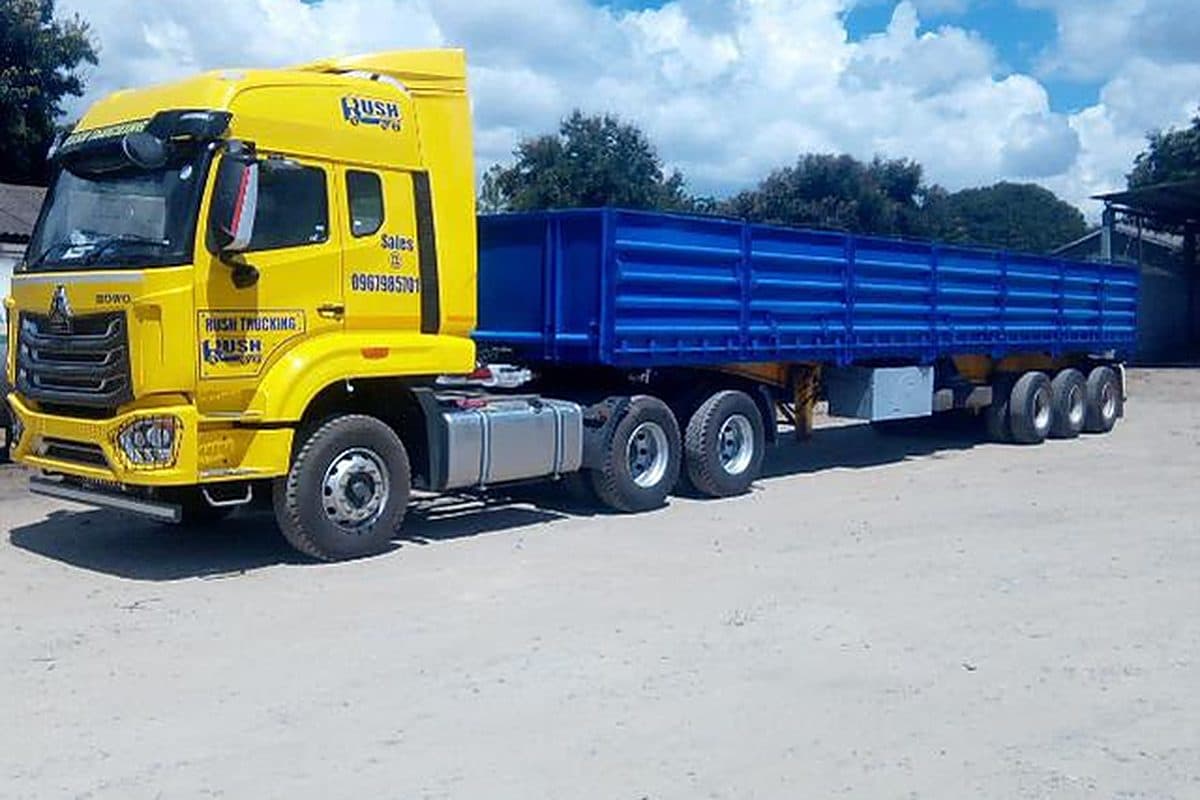 Rush Trucking truck and blue trailer combination in company livery
